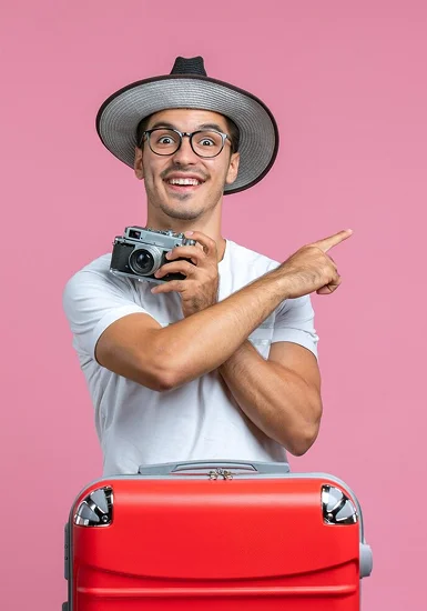 Happy traveler with camera and suitcase