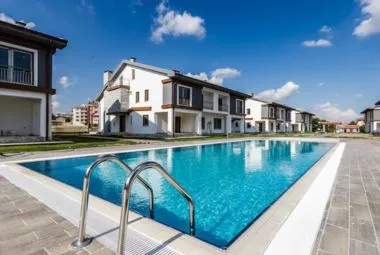 White Concrete Villas near Swimming Pool under Blue Sky